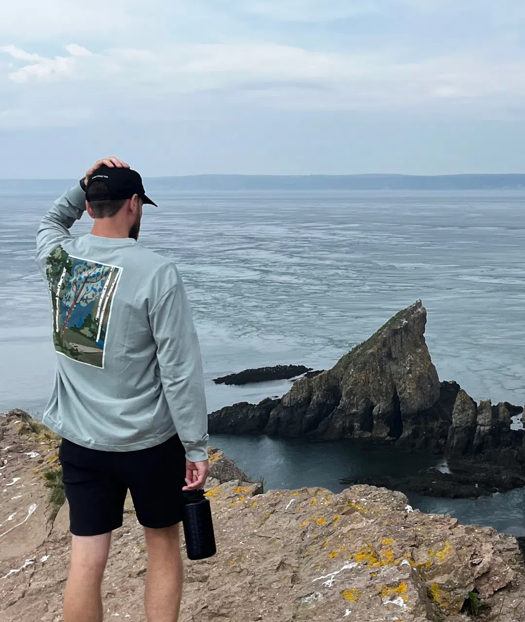Standing on a clifftop looking out over the water